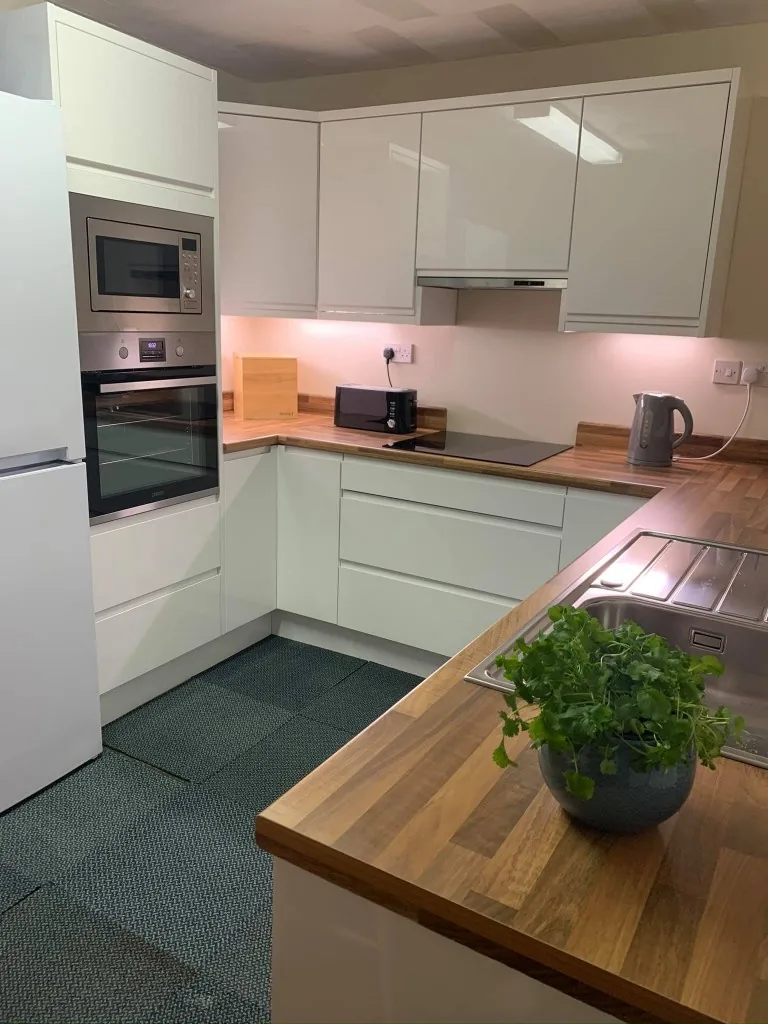 Cream kitchen with solid timber worktops and built-in oven housing